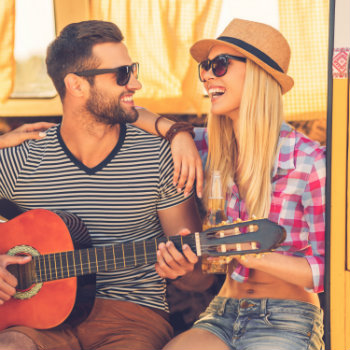 man playing guitar with his girlfriend